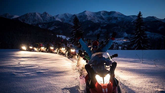Snowmobiles at night during the New Year's Eve tour