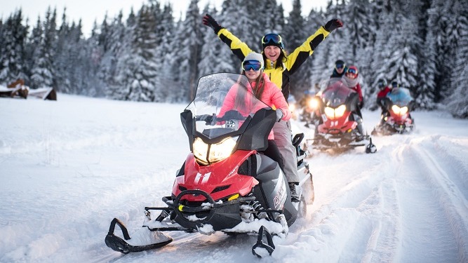 A group of snowmobiles on the FUN tour route in the mountains